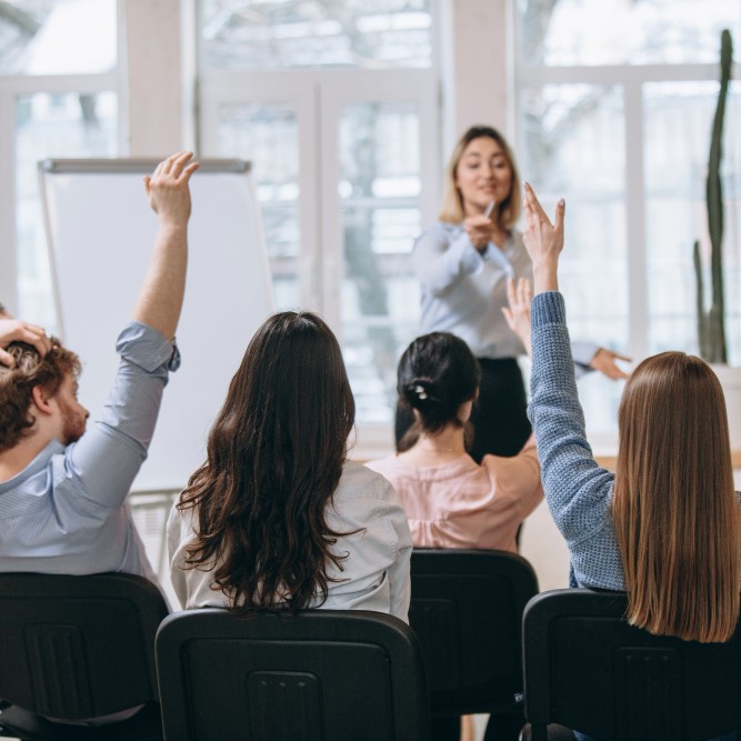 female-speaker-giving-presentation-hall-university-workshop-audience-conference-hall